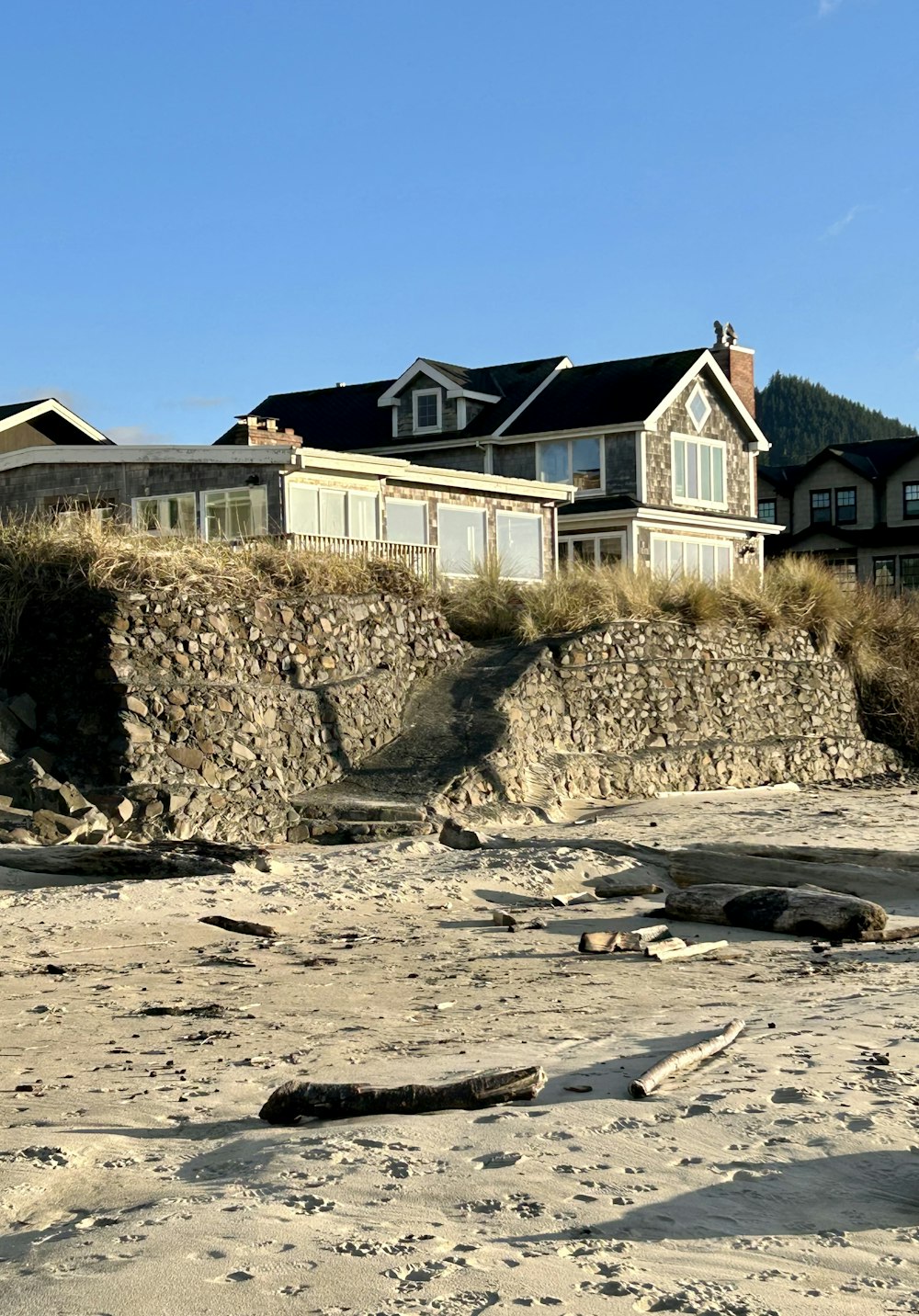 a beach with a house on top of a hill