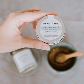 a person holding a jar of matcha oats
