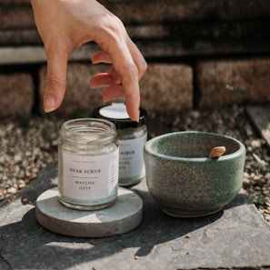 a hand reaching for a jar of matches