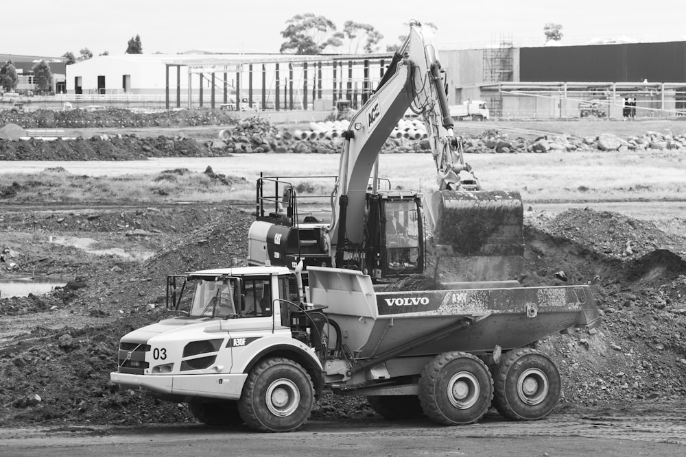 a black and white photo of a construction truck
