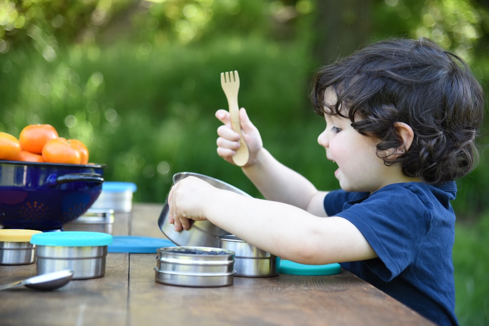 a little boy that is sitting at a table