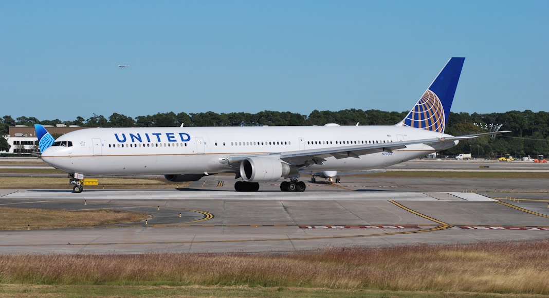 a united airlines plane on the runway at an airport