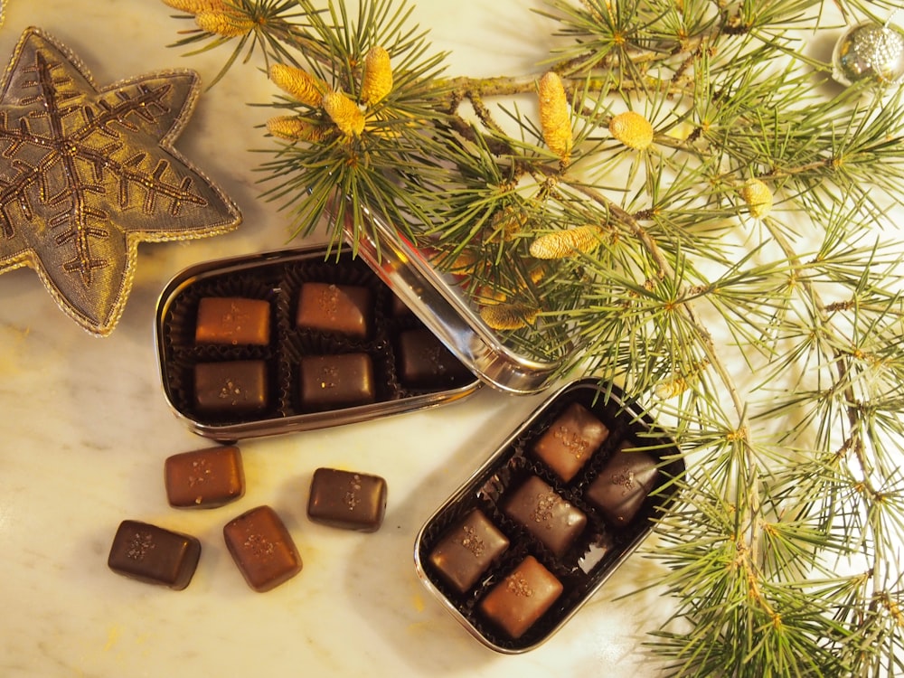 a couple of tins filled with chocolate on top of a table