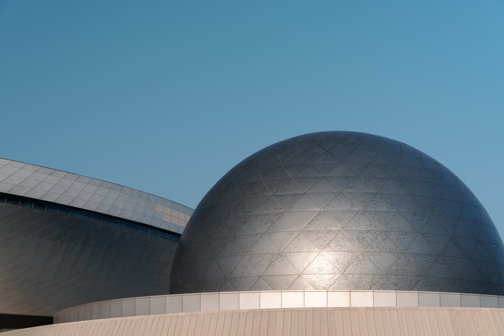 a large metal ball sitting on top of a building