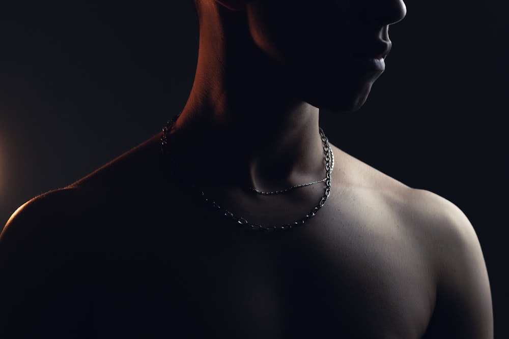 a man with a necklace on his neck