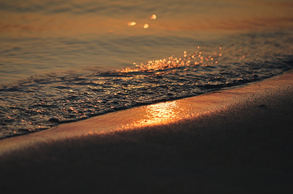 the sun shines on the beach as it reflects in the water