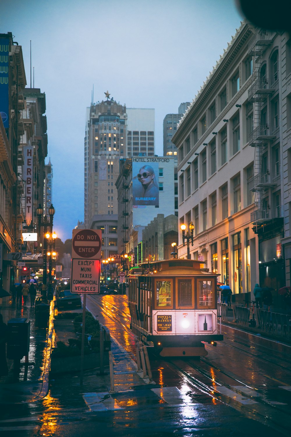 a trolley on a city street in the rain