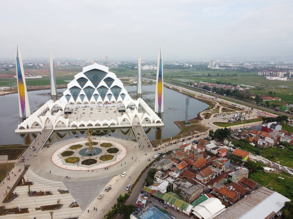 an aerial view of a building with a fountain in front of it