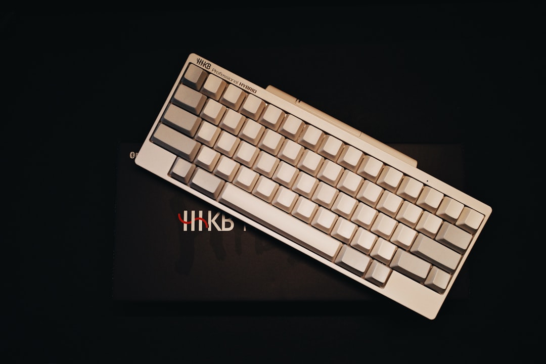 a white keyboard sitting on top of a black table