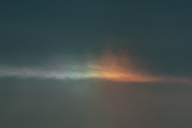 A serene dark blue sky with golden light breaking through clouds symbolizing hope.