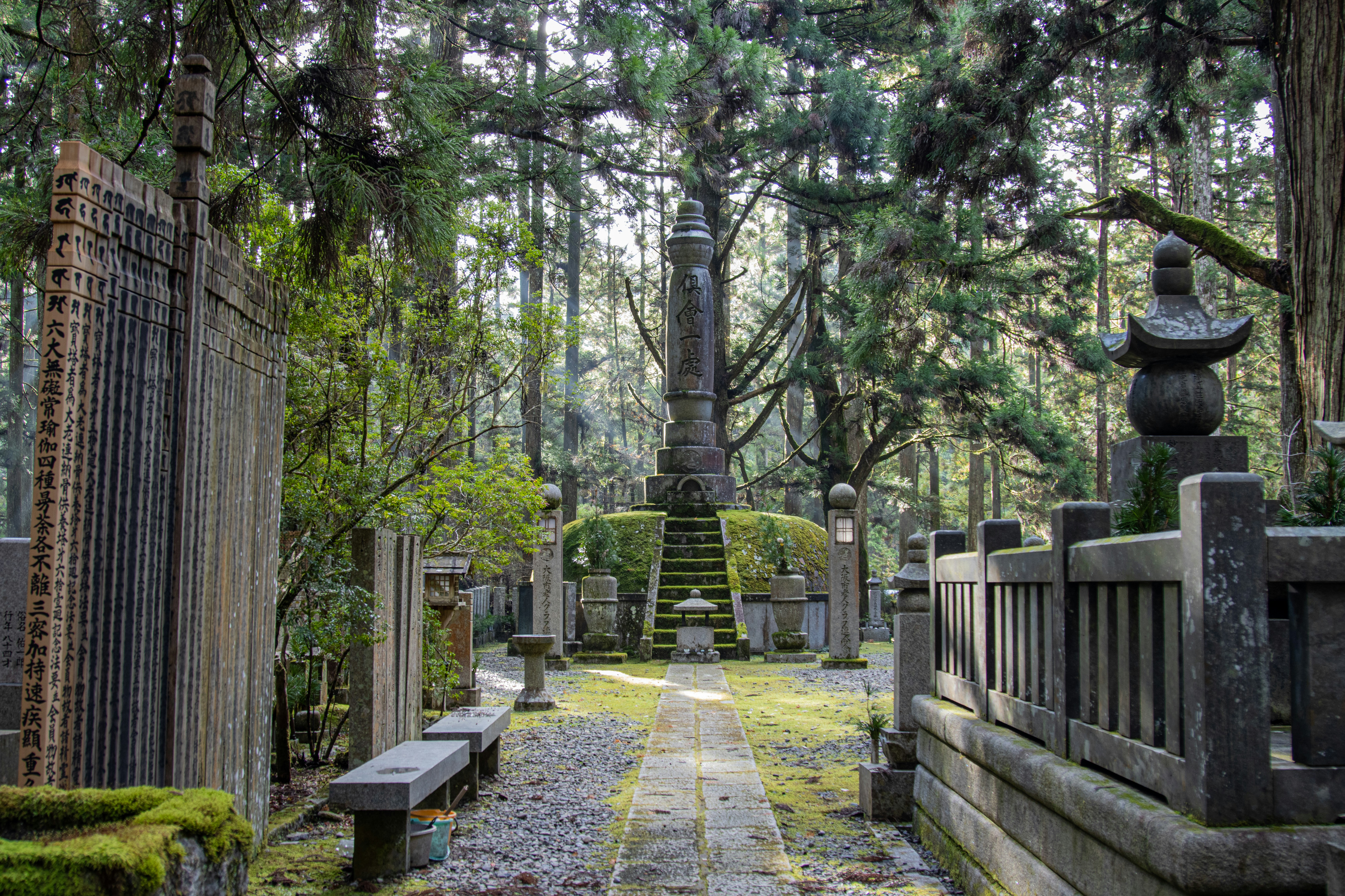 a cemetery with a tall tower in the middle of it, sacred graves in the Okunoin Cemetery