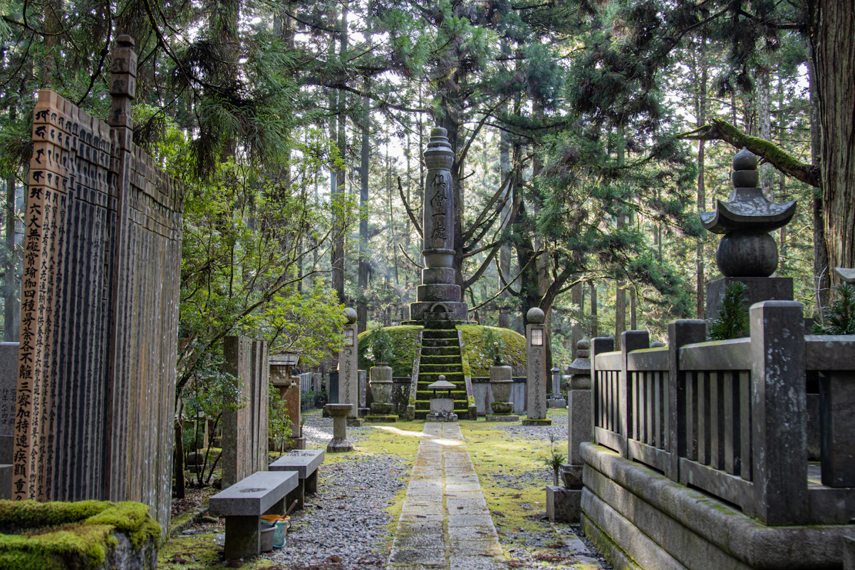 Stone stupas and memorials among tall cedars in the Okunoin cemetery, Koyasan