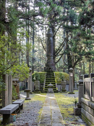 a cemetery with a tall tower in the middle of it