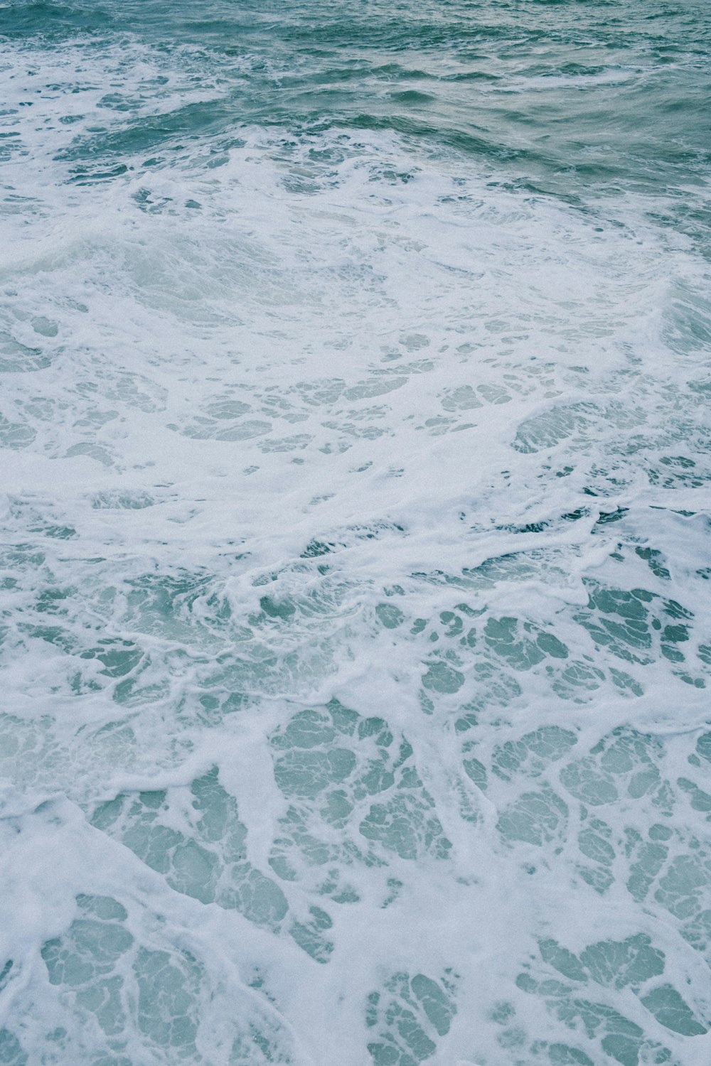 a person riding a surfboard on top of a wave