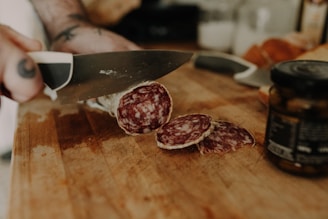 a person cutting up some food on a cutting board