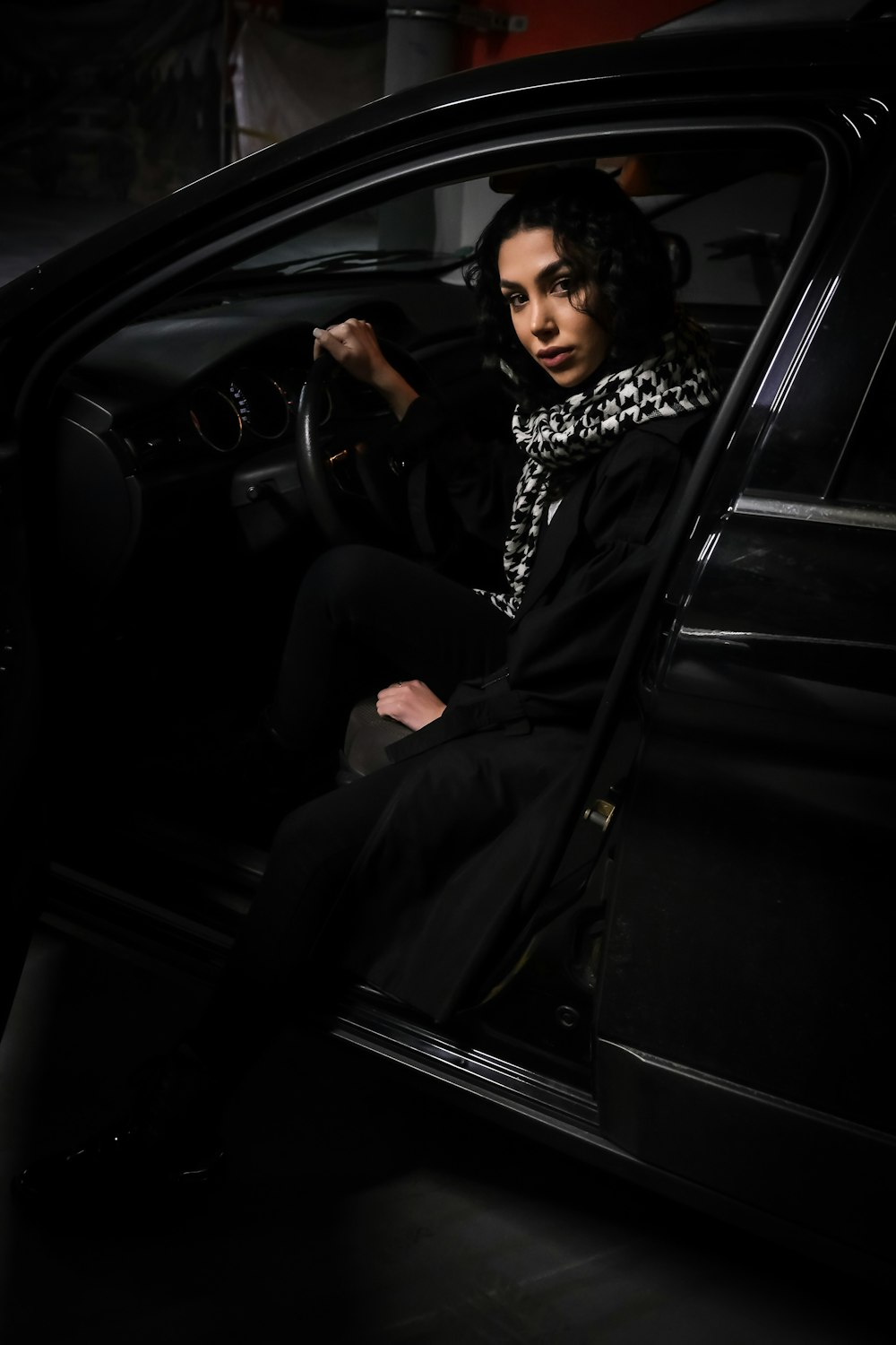 a woman sitting in the driver's seat of a car