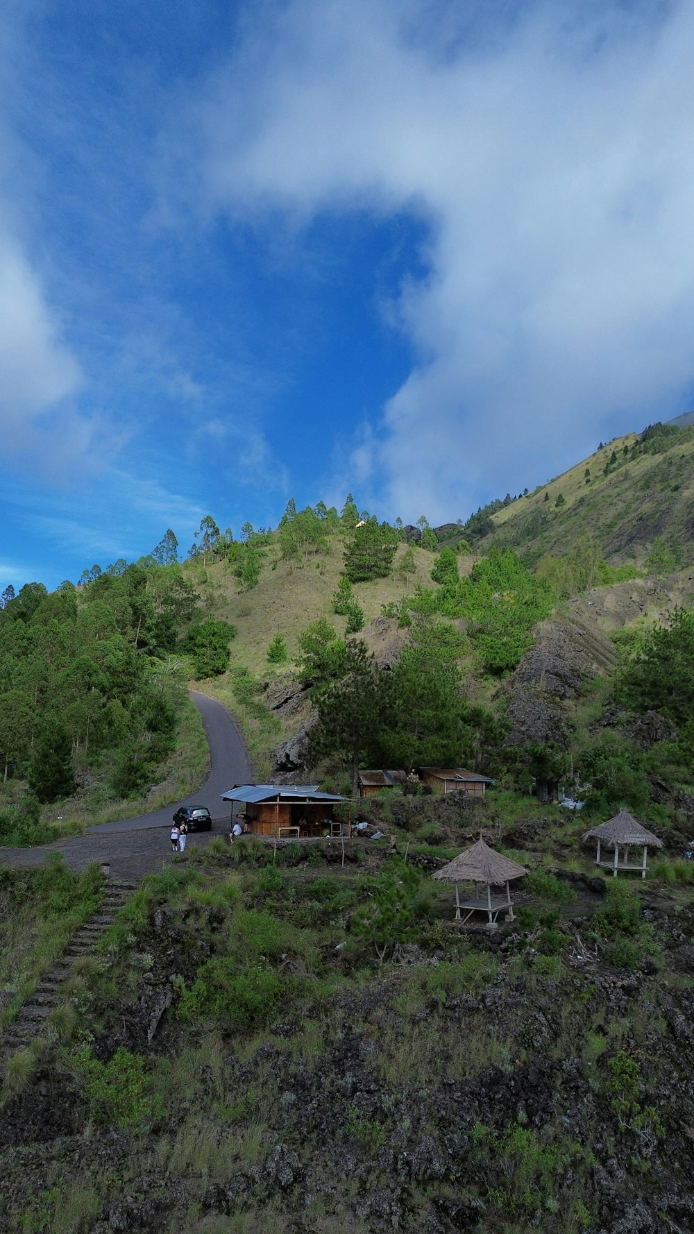 a scenic view of a hill with a road going through it