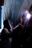 a man working on a piece of metal