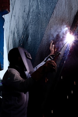 a man working on a piece of metal
