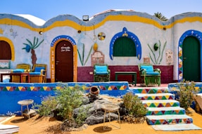 a colorfully painted building with steps leading up to it