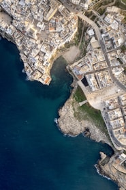 an aerial view of a large city next to a body of water