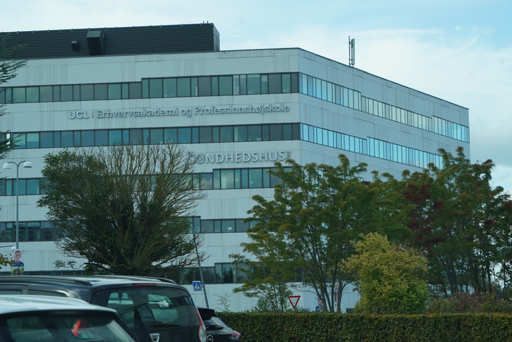 a large white building sitting next to a parking lot