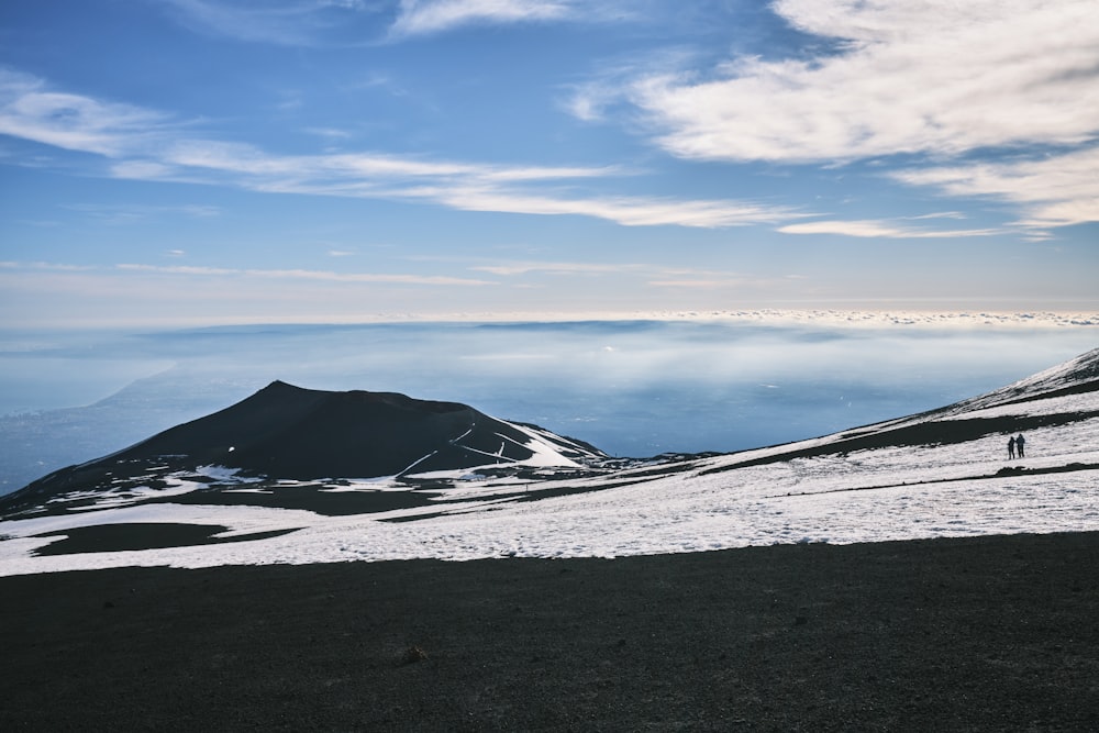 a person standing on top of a snow covered mountain