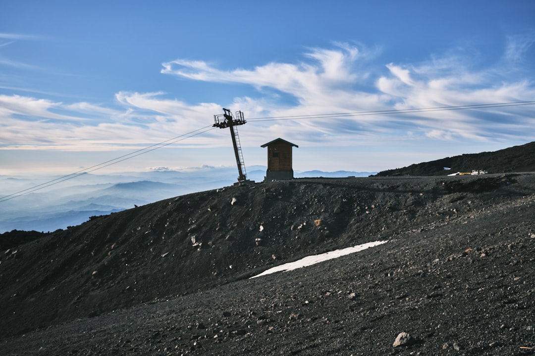 a hill with a house on top of it,