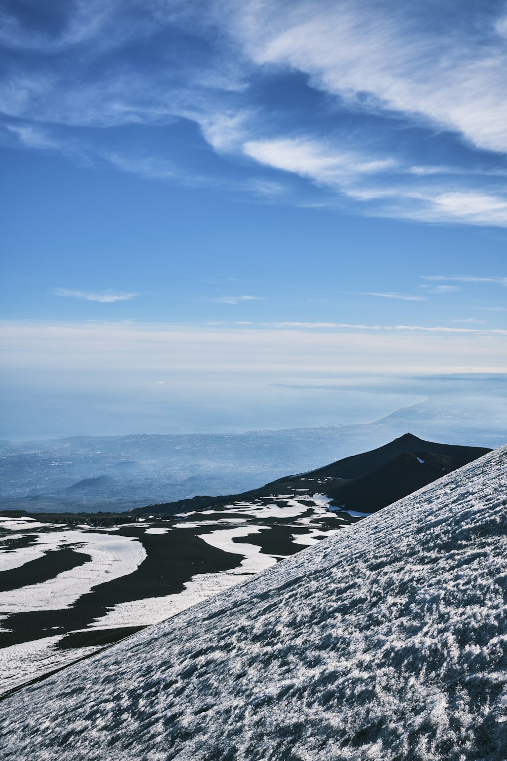 a person on a snowboard on top of a snow covered hill