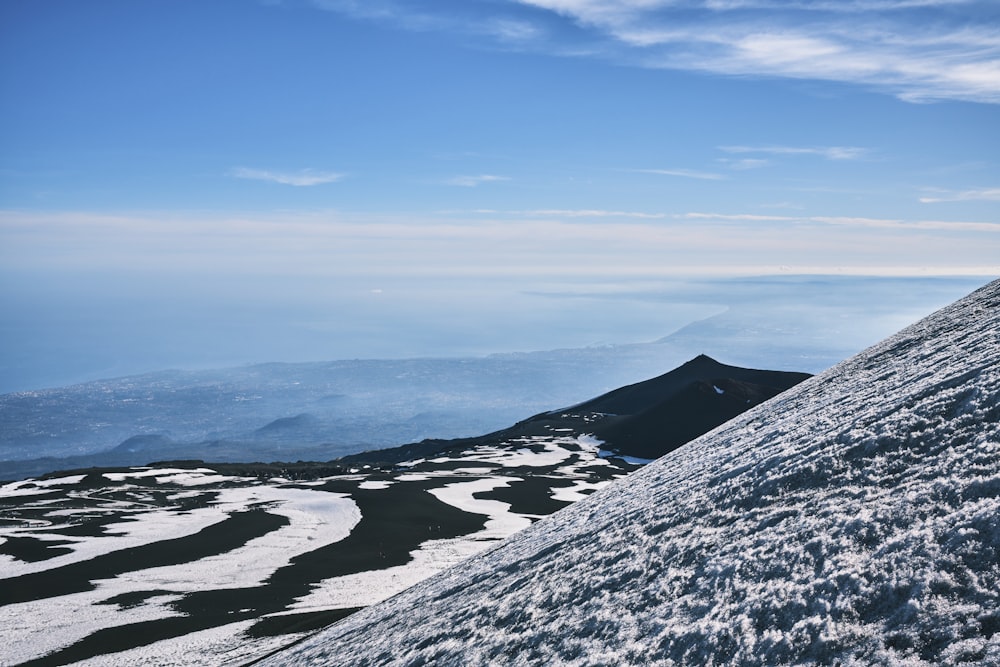 a person on a snowboard going down a snowy hill