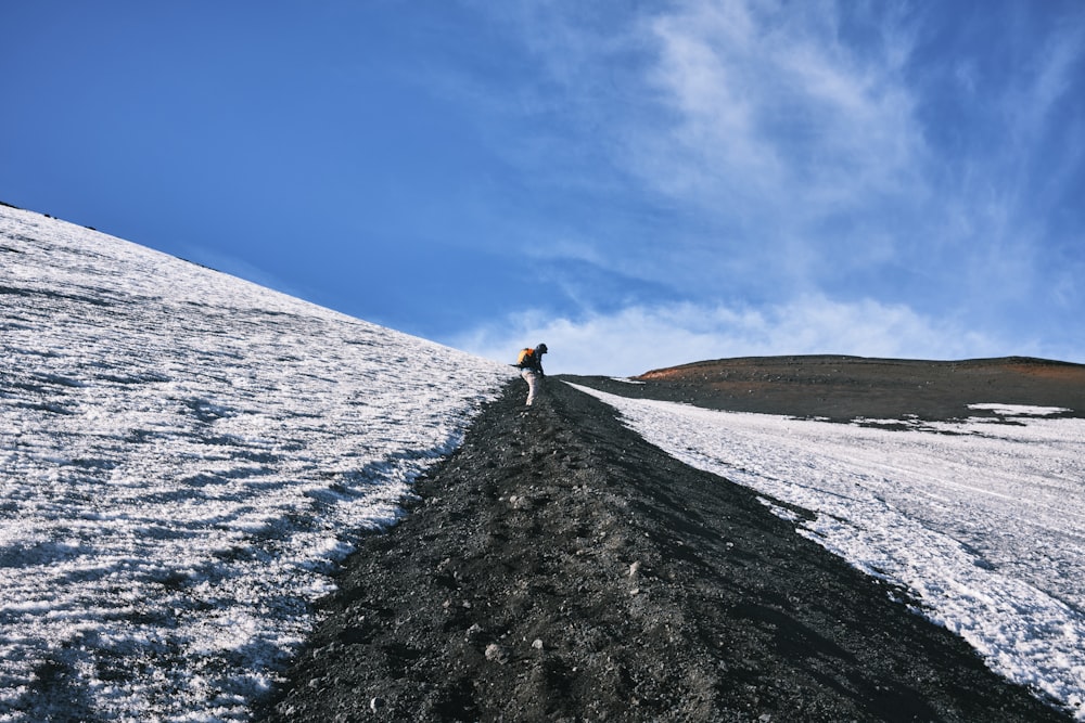 a person standing on top of a snow covered hill