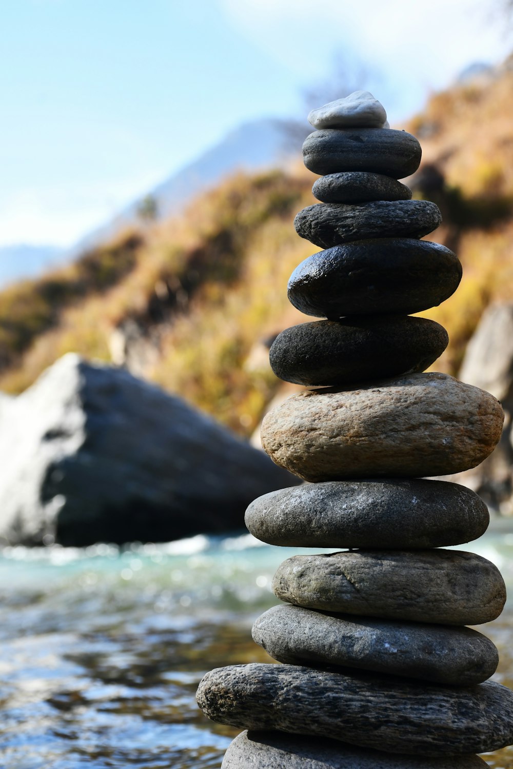 a stack of rocks sitting on top of a river