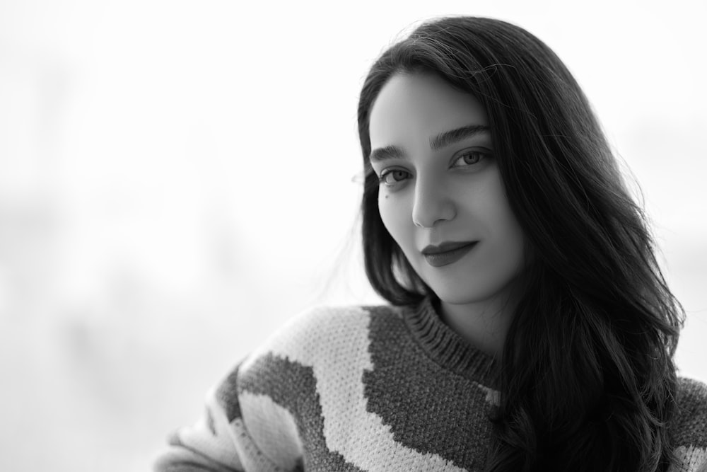 a black and white photo of a woman with long hair