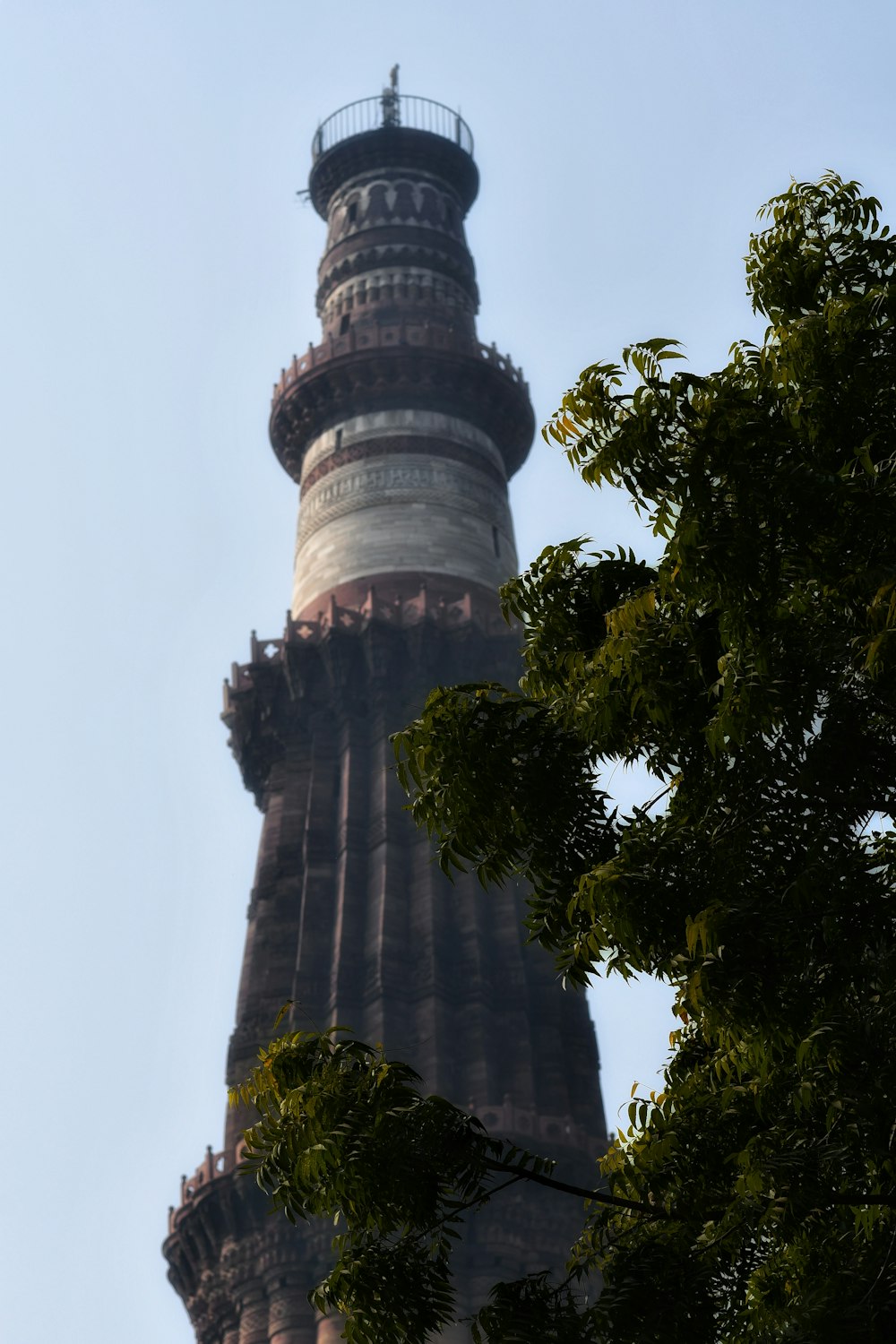 a very tall tower with a clock on it's side