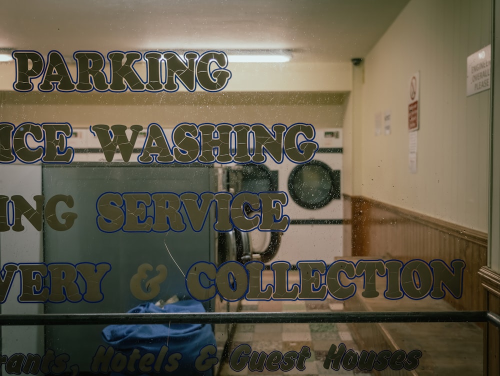 a glass sign that says parking service washing service delivery and collection