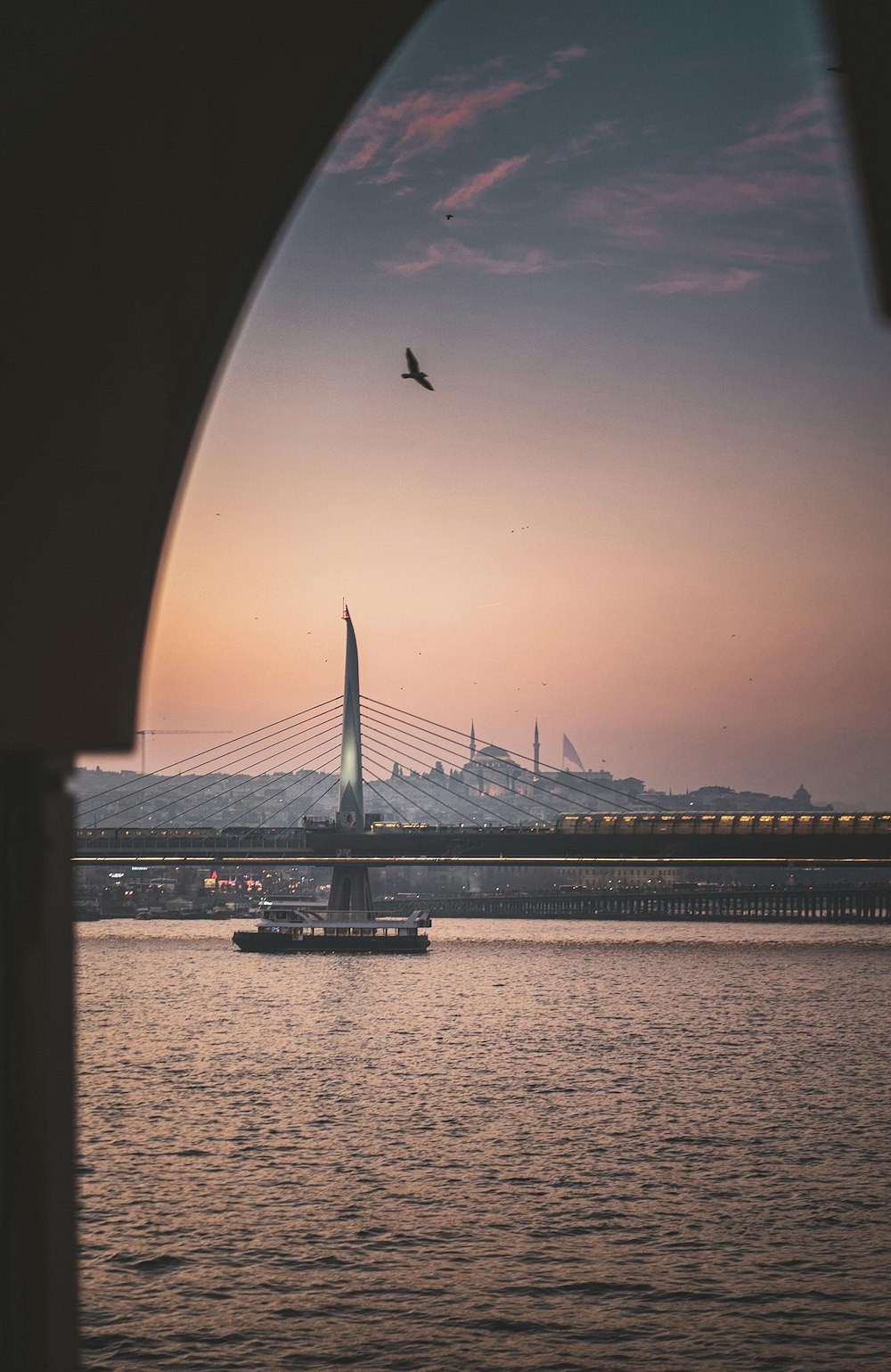 a large body of water with a bridge in the background