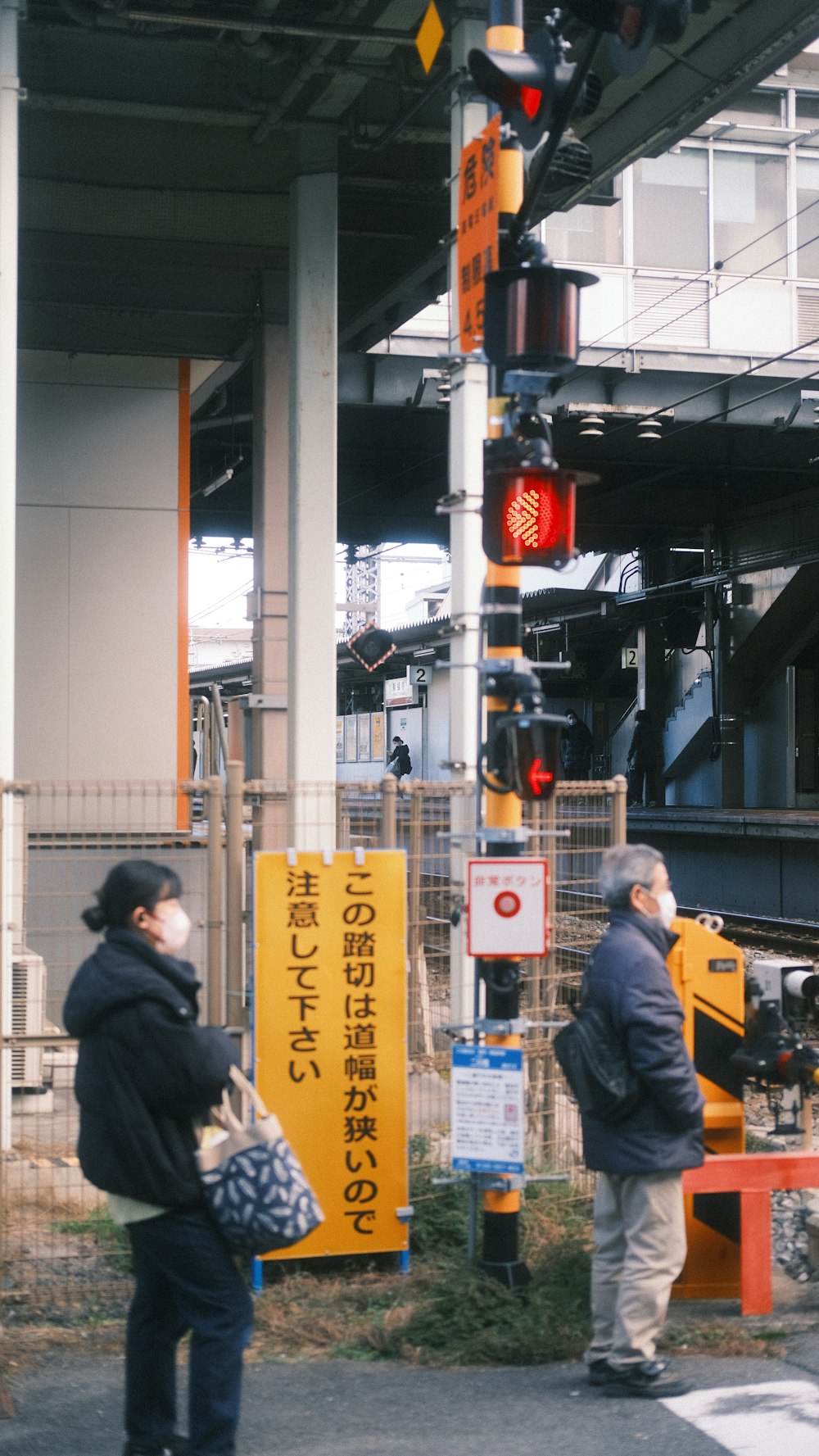 a couple of men standing next to a traffic light