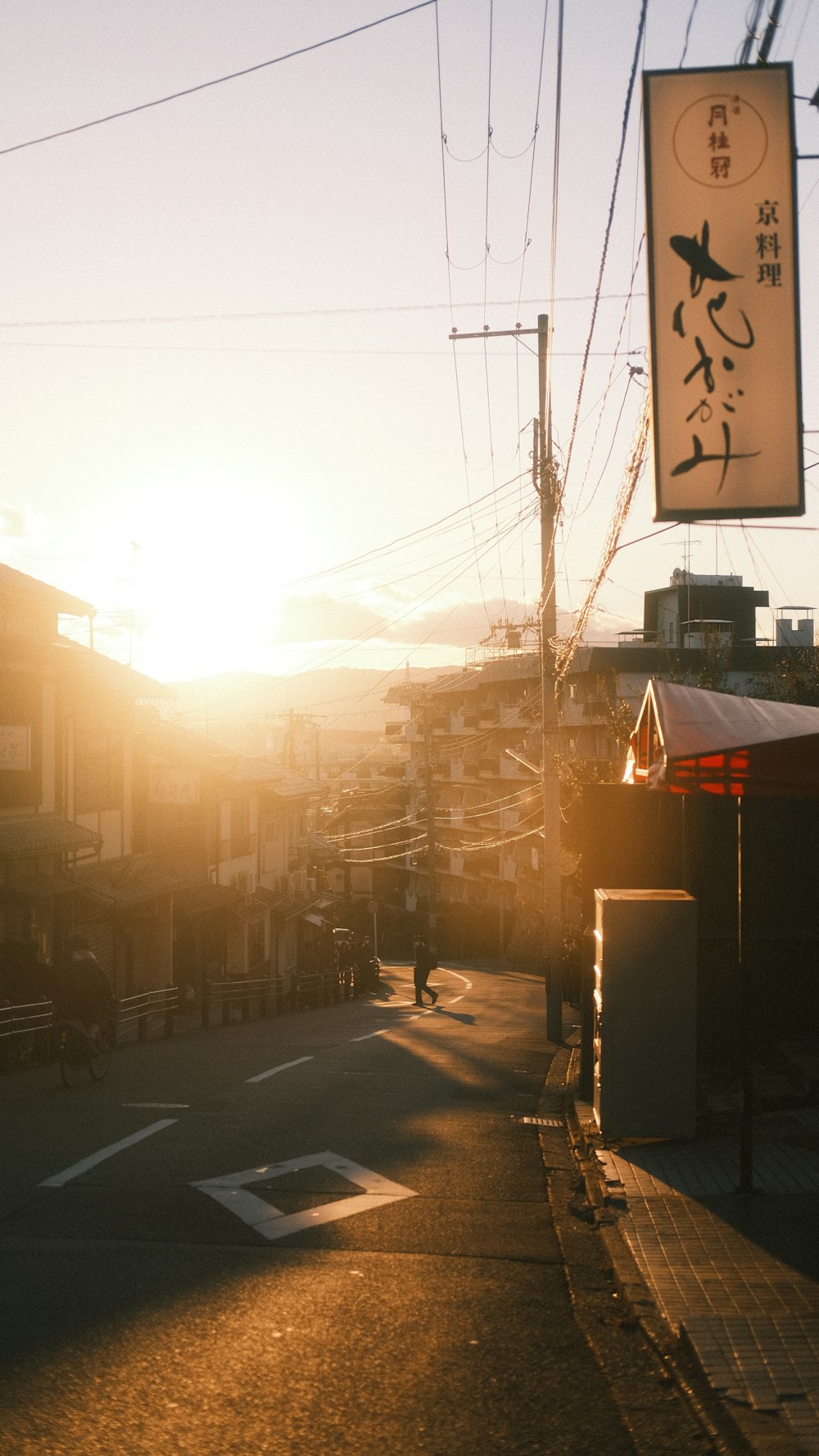 the sun is setting over a city street