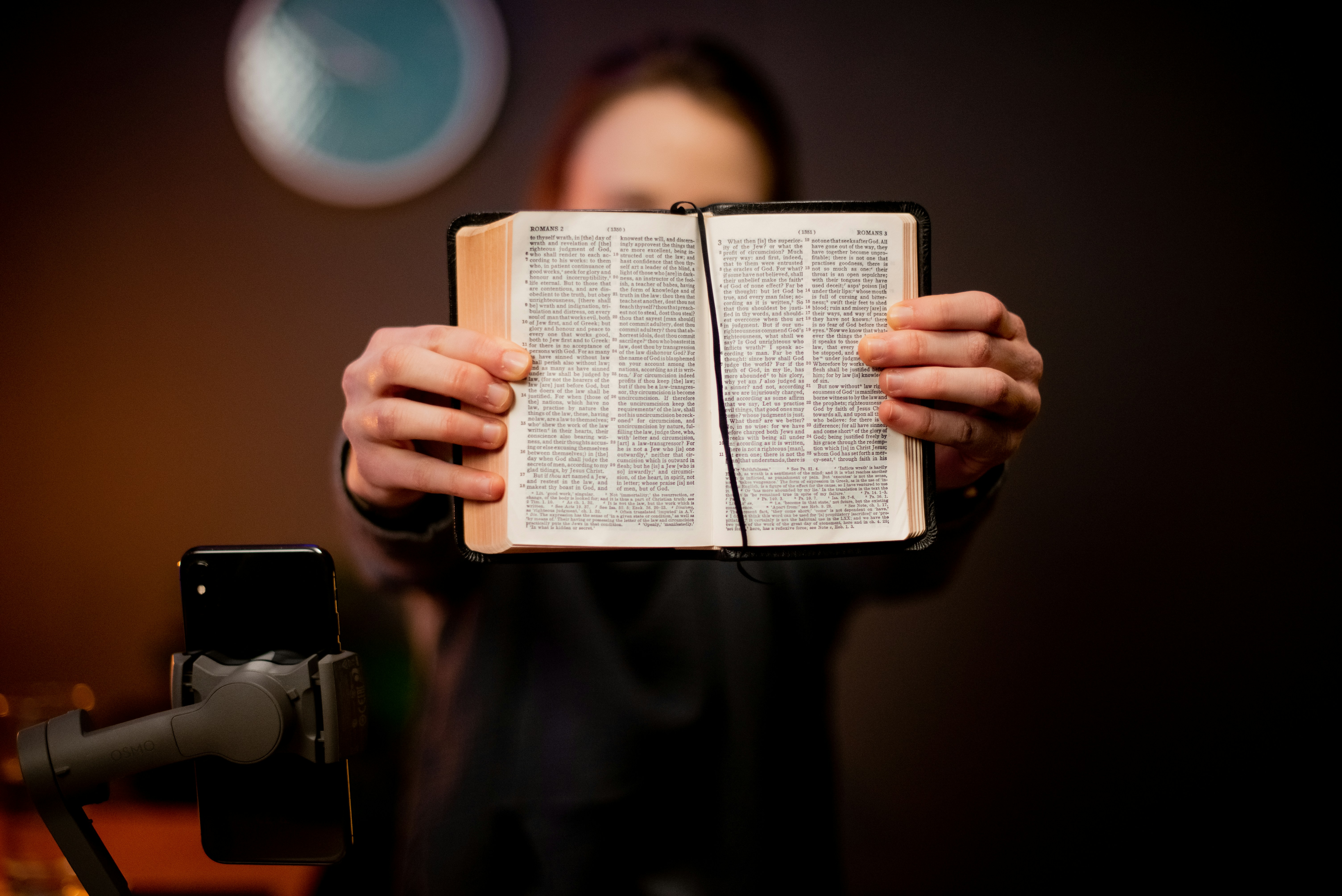 a person holding an open book in their hands