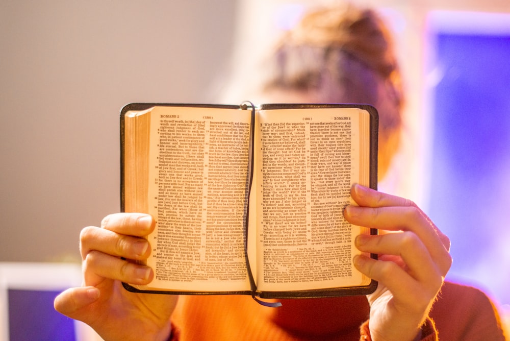 a woman holding a book in her hands