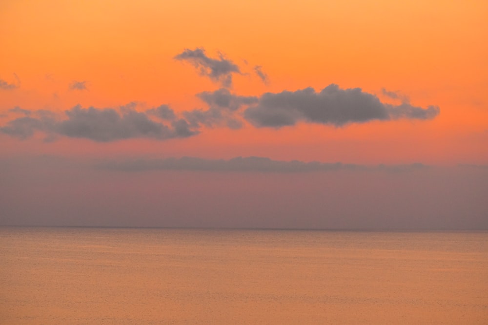 a large body of water under a cloudy sky