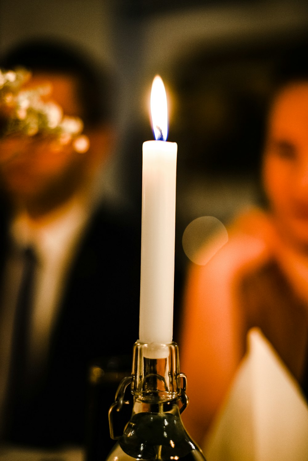 a white candle sitting on top of a table