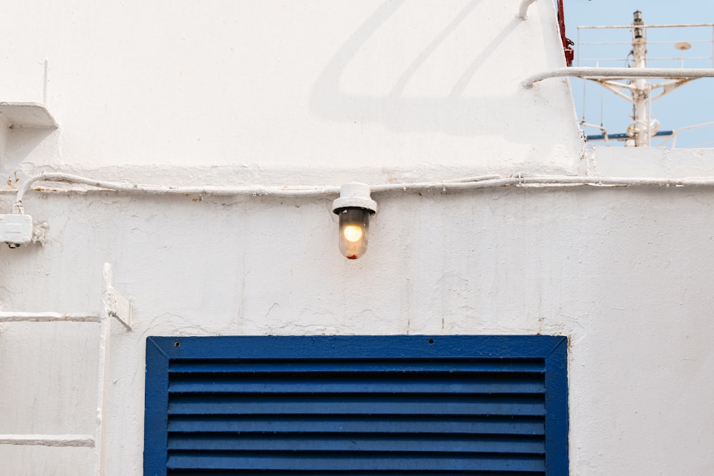 a blue and white building with a blue window