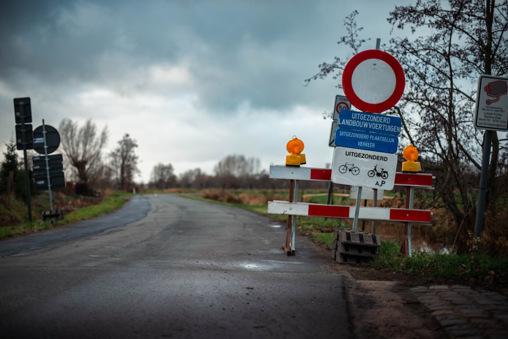 a road with a bunch of signs on the side of it