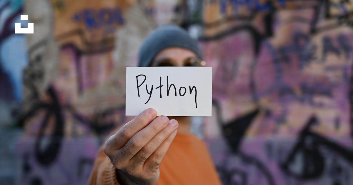 A man holding up a piece of paper with the word python written on it ...