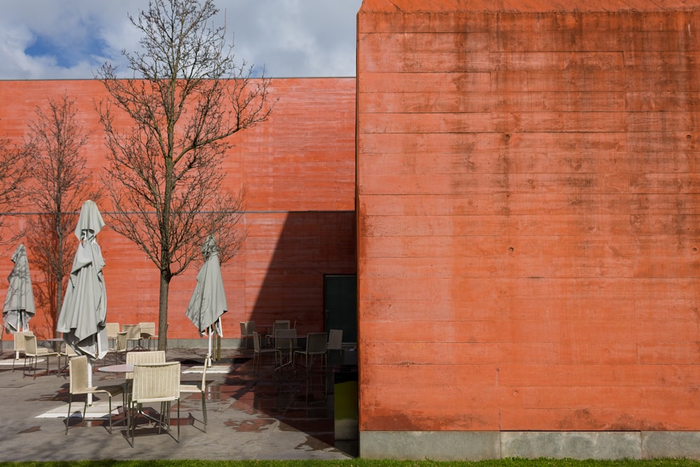 a building with tables and umbrellas outside of it