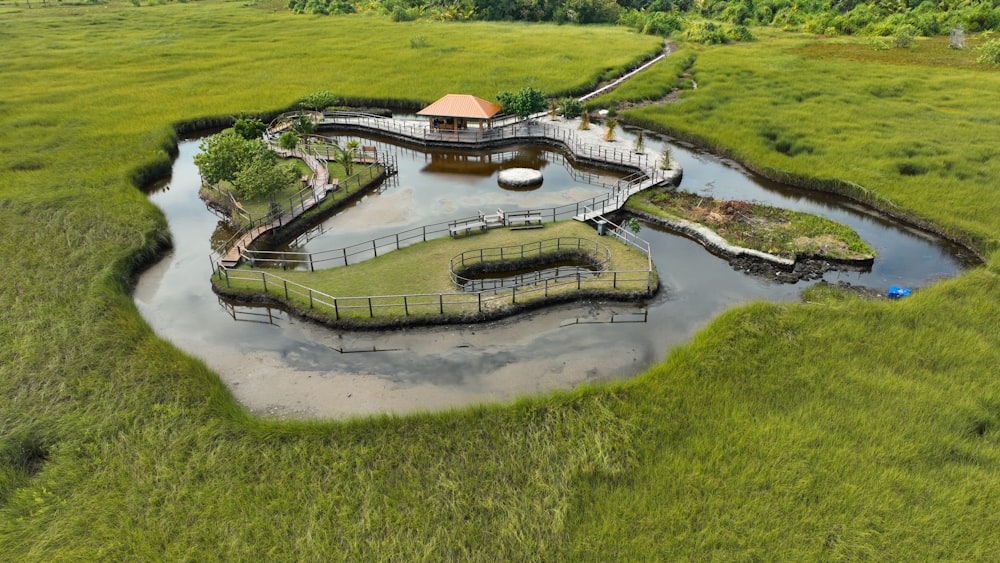 a bird's eye view of a pond and a bridge