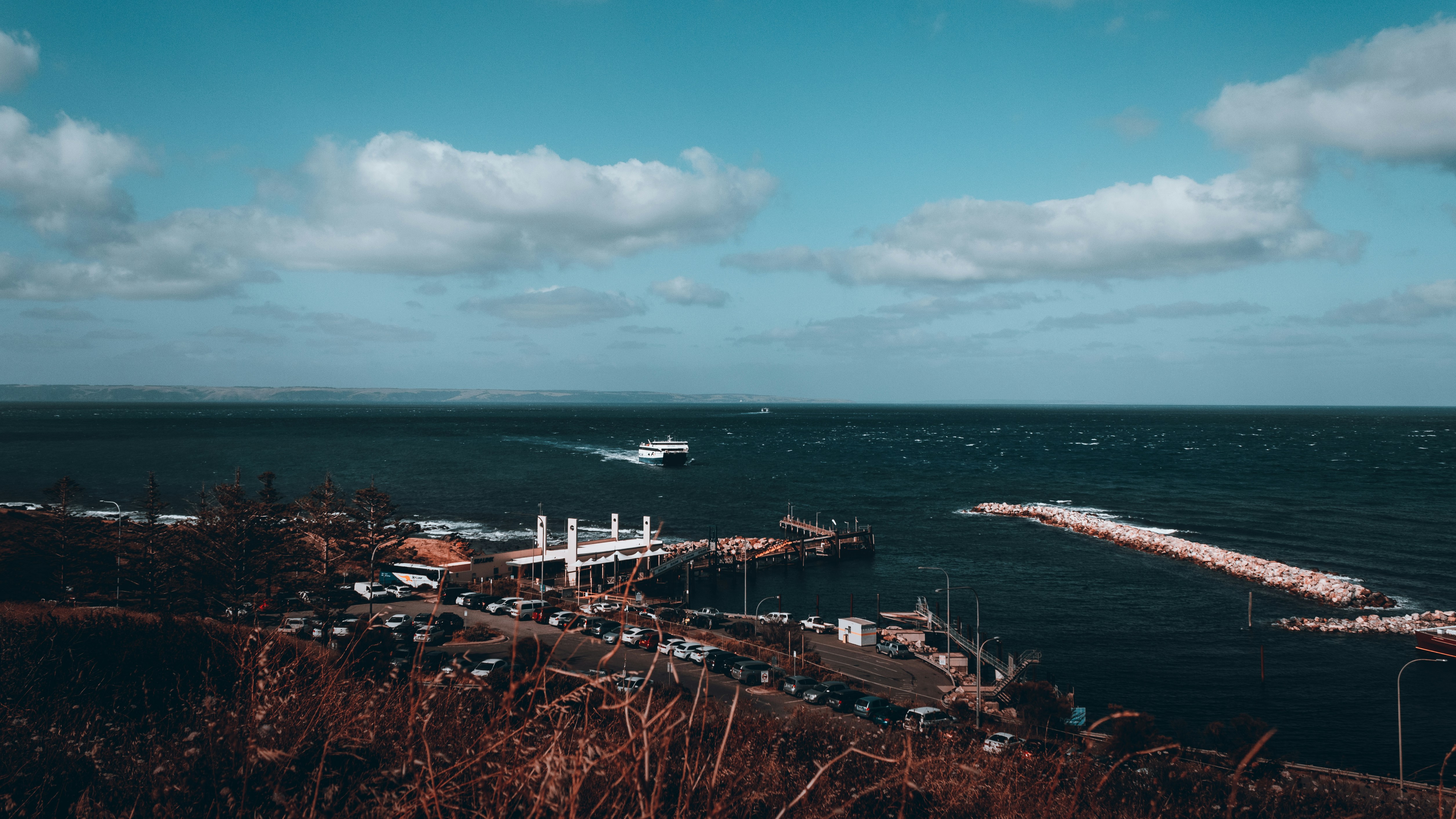 a boat is in the water near a pier, 