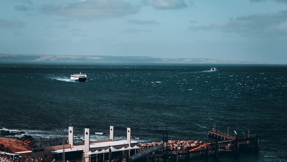 a boat is out on the water near a pier