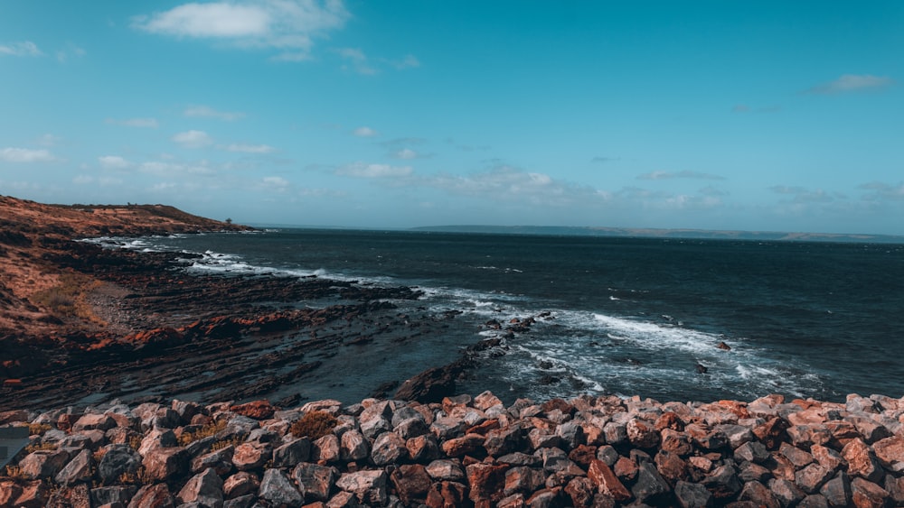 a view of the ocean from the top of a hill